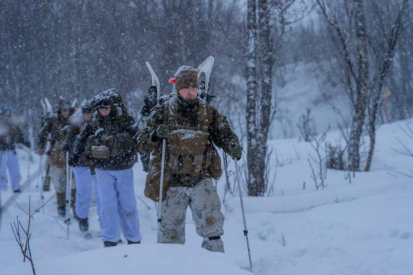 Marines slog through a snowstorm.