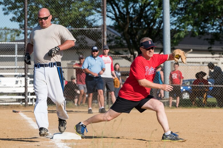 Senior Master Sgt. Bryan Mertzlufft, 436th Aircraft Maintenance Squadron Raptor flight chief, is called out at first base during the Chiefs versus Colonels softball game June 3, 2019, at Dover Air Force Base, Del. Col. Tyler Schaff, 436th Mission Support Group commander, caught the ball at first base for the out. (U.S. Air Force photo by Roland Balik)