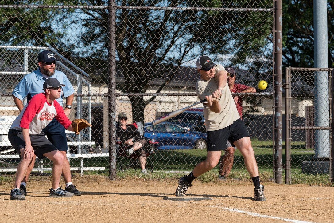 Colonels catcher, Lt. Col. David Bredesen, 436th Operations Support Squadron commander, watches Chief Master Sgt. Anthony Green, 436th Airlift Wing command chief, swing at a pitch during the Chiefs versus Colonels softball game June 3, 2019, at Dover Air Force Base, Del. The Chiefs held off a late rally by the Colonels in the bottom of the seventh inning for the win, 16-15. (U.S. Air Force photo by Roland Balik)