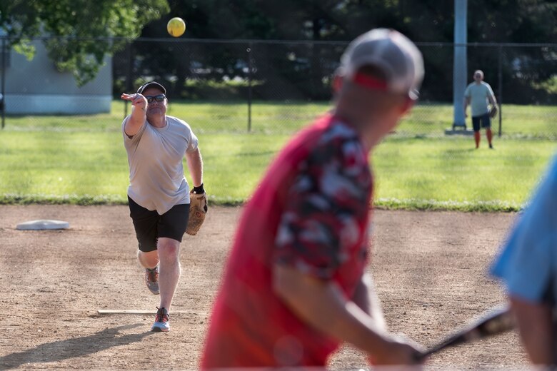 Chief Master Sgt. Paul Barker, 436th Mission Support Group acting group superintendent, pitches the ball to Lt. Col. Travis Guidt, 436th Civil Engineer Squadron commander during the Chiefs versus Colonels softball game June 3, 2019, at Dover Air Force Base, Del. Guidt pitched for the Colonels who lost in a close game 16-15. (U.S. Air Force photo by Roland Balik)