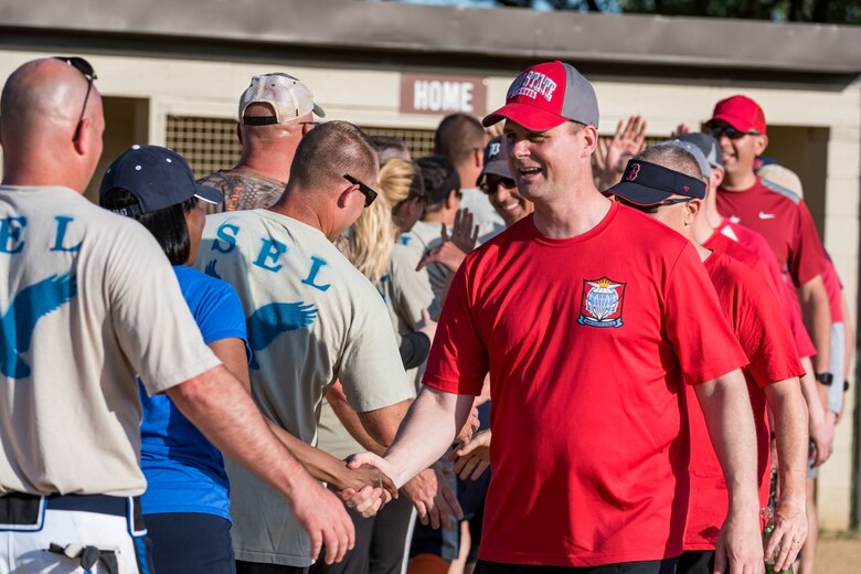 Col. Joel Safranek, 436th Airlift Wing commander, leads the Colonels on congratulating the Chiefs at the conclusion of their softball game June 3, 2019, at Dover Air Force Base, Del. The Colonels rallied late in the game but came up short, losing to the Chiefs, 16-15. (U.S. Air Force photo by Roland Balik)