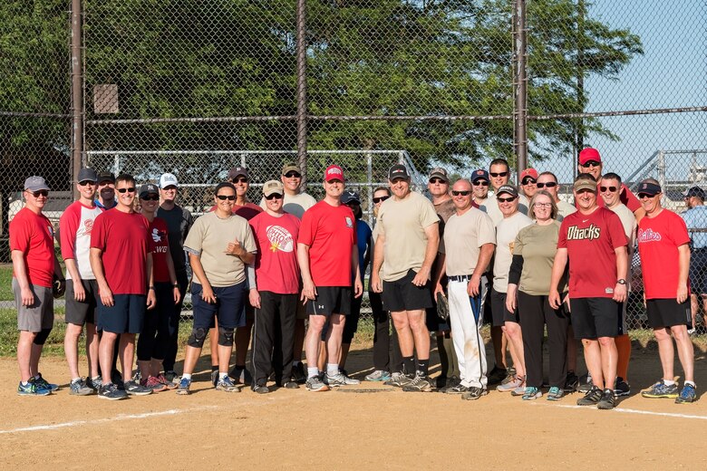 In the center, Col. Joel Safranek, 436th Airlift Wing commander, and Chief Master Sgt. Anthony Green, 436th AW command chief, pose for a photo with other colonels and chiefs at the conclusion of their softball game June 3, 2019, at Dover Air Force Base, Del. To kick off the start of the intramural softball season, the Colonels played the Chiefs in a close game. The Chiefs won the game, 16-15. (U.S. Air Force photo by Roland Balik)