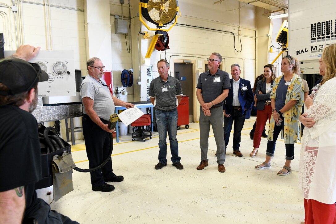 Travis Hensley, 97th Maintenance Squadron AGE maintainer, explains the purpose of their equipment to the honorary commanders during the Honorary Commanders Boot Camp, May 31, 2019, at Altus Air Force Base, Okla. The honorary commanders toured the Aerospace Ground Equipment shop where they learned additional information about maintenance procedures at the 97th Air Mobility Wing. (U.S. Air Force Photo by Senior Airman Jackson N. Haddon)