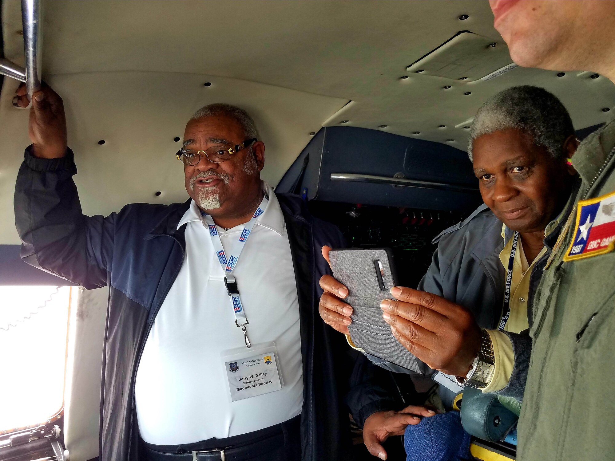 Jerry W. Dailey (left), Macedonia Baptist senior pastor and the Rev. Ruben Archield, Friendship Baptist Church, observe the south Texas landscape from the cockpit of a C-5M Super Galaxy.