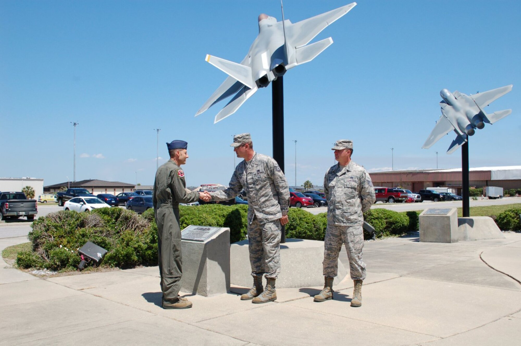 The sculptures represents the schoolhouse for raptor pilot training and are a symbol of Air Dominance.