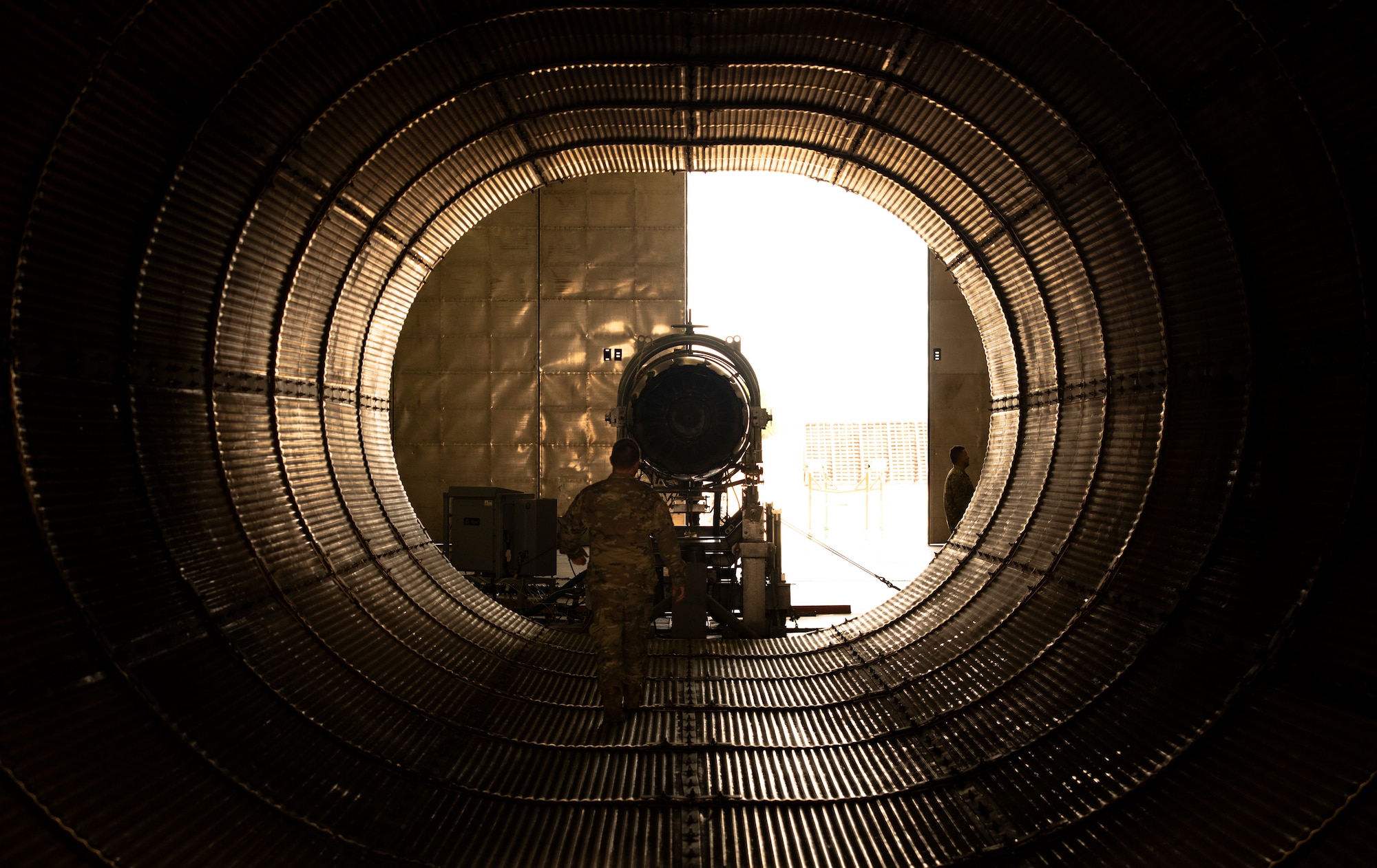 U.S. Air Force Staff Sgt. Kyle Halsey, 20th Component Maintenance Squadron engine test facility (ETF) craftsman, walks through the ETF exhaust nozzle prior to performing a General Electric F110-GE-129 engine inspection at Shaw Air Force Base, S.C., May 28, 2019.