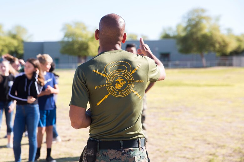 U.S. Marines assigned to Marine Air Control Squadron (MACS) 1 participate in MACS-1's Marine Week at Ron Watson Middle School in Yuma, Ariz., March 29, 2019. The third and last day of Marine Week consisted of students conducting a modified Combat Fitness Test, tasting food from Meal, Ready-to-Eat (MRE), trying on Marine Corps equipment; flak jackets, gas masks, etc., and interacting with the Marines. (U.S. Marine Corps photo by Cpl. Sabrina Candiaflores)