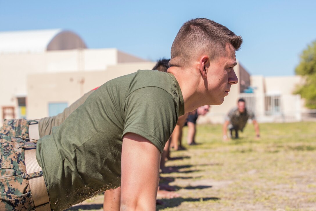 U.S. Marines assigned to Marine Air Control Squadron (MACS) 1 participate in MACS-1's Marine Week at Ron Watson Middle School in Yuma, Ariz., March 29, 2019. The third and last day of Marine Week consisted of students conducting a modified Combat Fitness Test, tasting food from Meal, Ready-to-Eat (MRE), trying on Marine Corps equipment; flak jackets, gas masks, etc., and interacting with the Marines. (U.S. Marine Corps photo by Cpl. Sabrina Candiaflores)