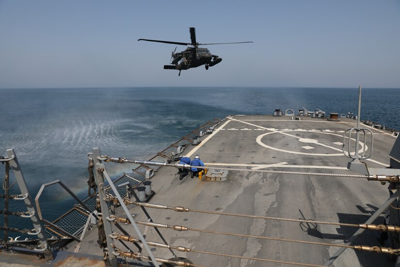 U.S. Navy Sailors aboard the Arleigh Burke-class guided-missile destroyer USS Gonzalez (DDG 66), wait to secure a U.S. Army UH-60 Black Hawk helicopter assigned to Bravo Company, 2nd Battalion, 147th Aviation Regiment currently attached to 8th Battalion, 229th Assault Helicopter Battalion, during deck landing qualifications May 22, 2019 in the Arabian Gulf. The deck landing qualifications where held to increase interoperability between U.S. Army and U.S. Navy personnel.