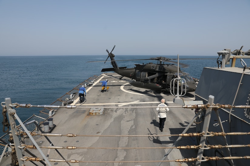 U.S. Navy Sailors aboard the Arleigh Burke-class guided-missile destroyer USS Gonzalez (DDG 66), approach a U.S. Army UH-60 Black Hawk helicopter, assigned to Bravo Company, 2nd Battalion, 147th Aviation Regiment currently attached to 8th Battalion, 229th Assault Helicopter Battalion, during deck landing qualifications May 22, 2019, in the Arabian Gulf. Deck landing qualifications where held to increase interoperability between U.S. Army and U.S. Navy personnel.