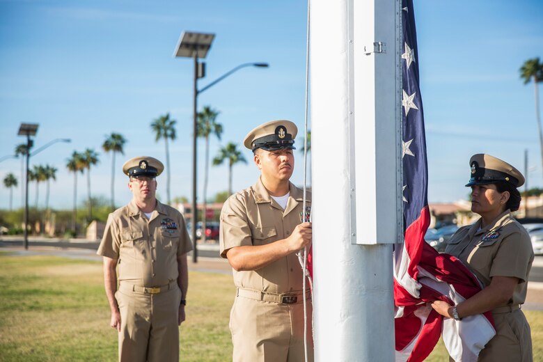 U.S. Navy Chiefs aboard Marine Corps Air Station (MCAS) Yuma observe morning colors on the station's parade deck, April 1, 2019 in celebration of the 126th Birthday of the Chief Petty Officer. The Corpsmen raised the flag at half-staff in honor of Maj. Matthew M. Wiegand and Capt. Travis W. Brannon, the two Marine Corps pilots killed in the AH-1Z Viper Helicopter crash March 30, 2019. (U.S. Marine Corps photo by Cpl. Sabrina Candiaflores)