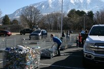 Boy Scouts and volunteers unload food at the Community Action Services and Food Bank in Orem, March 16, 2019 during Scouting for Food.
