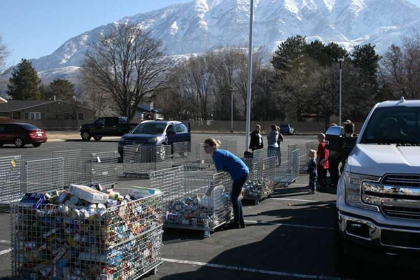 Boy Scouts and volunteers unload food at the Community Action Services and Food Bank in Orem, March 16, 2019 during Scouting for Food.