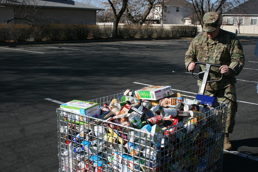 Boy Scouts and volunteers unload food at the Community Action Services and Food Bank in Orem, March 16, 2019 during Scouting for Food.