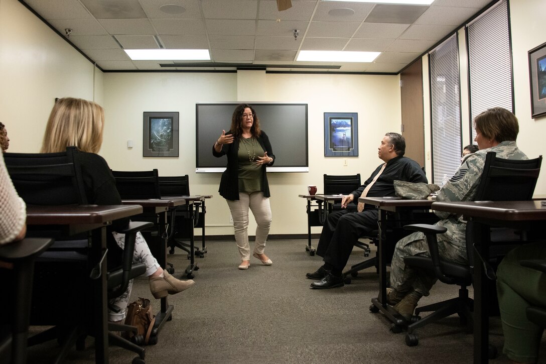 Danna Plewe, Air Force Employee Assistance Program (AF EAP) Manager, talks to members of the 97th Force Support Squadron Airman and Family Readiness Center (A&FRC) about the AF EAP