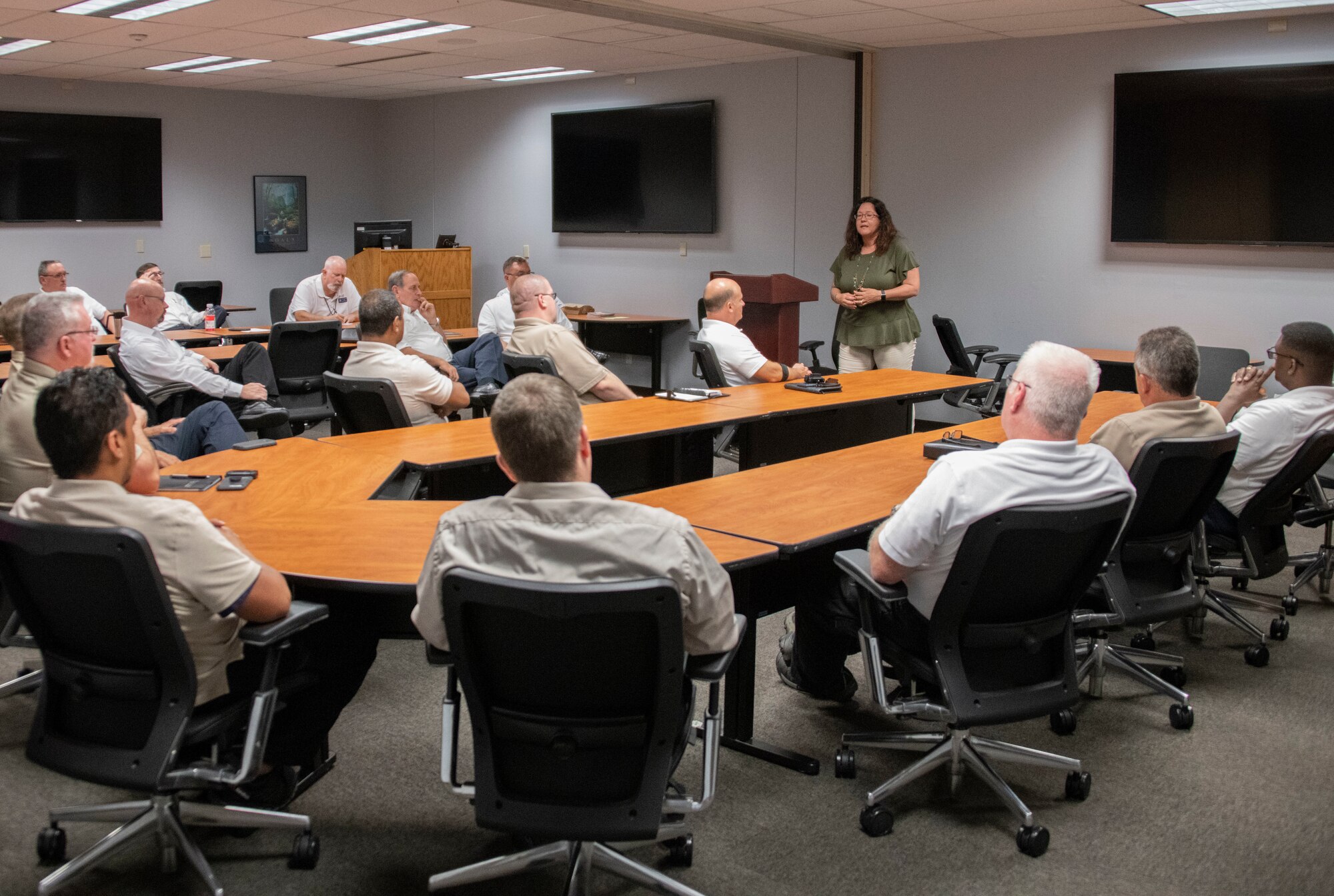 Danna Plewe, Air Force Employee Assistance Program (AF EAP) Manager, talks to leadership of the 97th Maintenance Group,