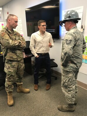 Chief Master Sgt. Christopher McEwan and Tech Sgt. Todd Grace, 366th Maintenance Squadron, work with a company representative, testing out their product. Working with companies can bring solutions to the warfighter faster.