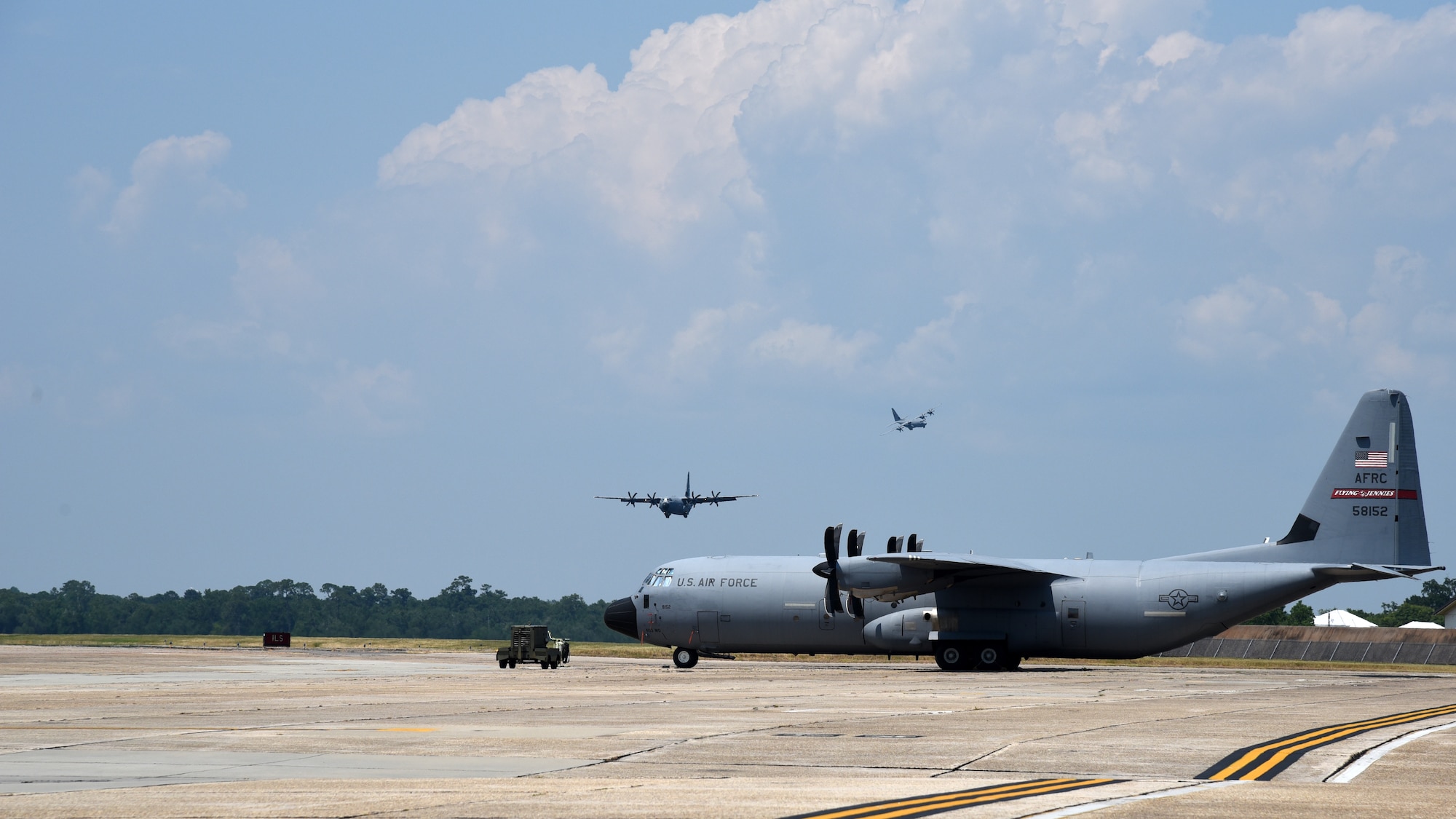 Two 815th Airlift Squadron C-130J Super Hercules aircraft prepare to land at Keesler Air Force Base, June 4, 2019. Lt. Col. Keith Gibson, 403rd Operations Group deputy commander, flew the lead aircraft of a two ship flight during his final flight with the “Flying Jennies.” (U.S. Air Force photo by Tech. Sgt. Christopher Carranza)