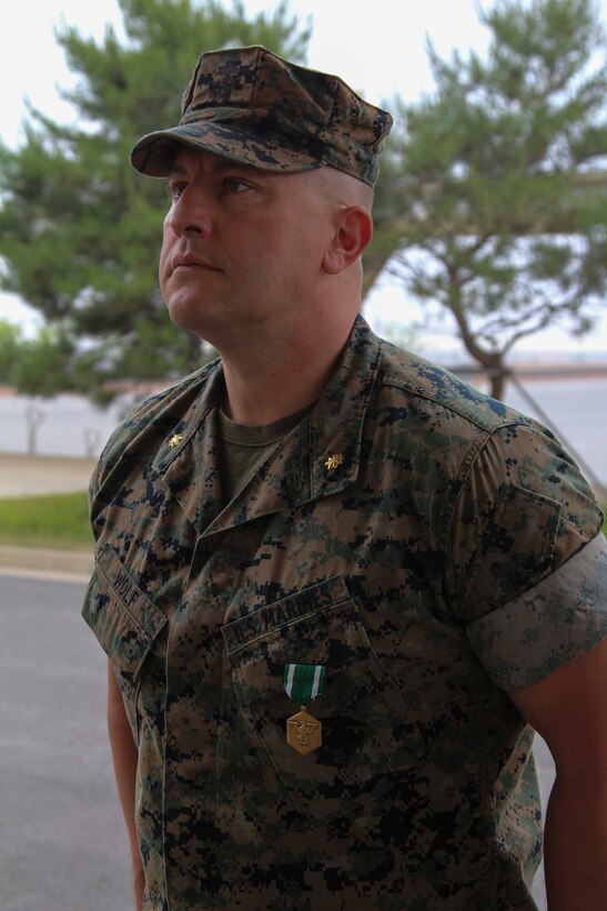 CAMP HUMPHREYS, Republic of Korea – Maj. Cameron Wolf, U.S. Marine Corps Forces Korea G3 future operations officer, receives the Navy and Marine Corps Commendation Medal during an awards ceremony here, June 5. Wolf was awarded for his unwavering devotion to duty and contributions to the unit during his time with MARFORK. (Official U.S. Marine Corps photo by Sgt. Nathaniel Hanscom/Released)