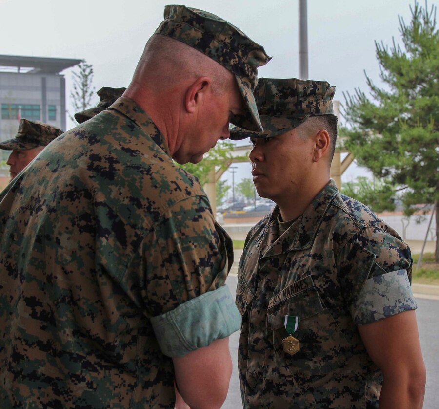 CAMP HUMPHREYS, Republic of Korea – Gunnery Sgt. Hung Tran, U.S. Marine Corps Forces Korea G1 administration chief, receives the Navy and Marine Corps Commendation Medal during an awards ceremony here, June 5. Tran was awarded for his excellence in leading the administration section of MARFORK, executing his daily duties without error and ensuring all administrative needs of the unit were met. (Official U.S. Marine Corps photo by Sgt. Nathaniel Hanscom/Released)