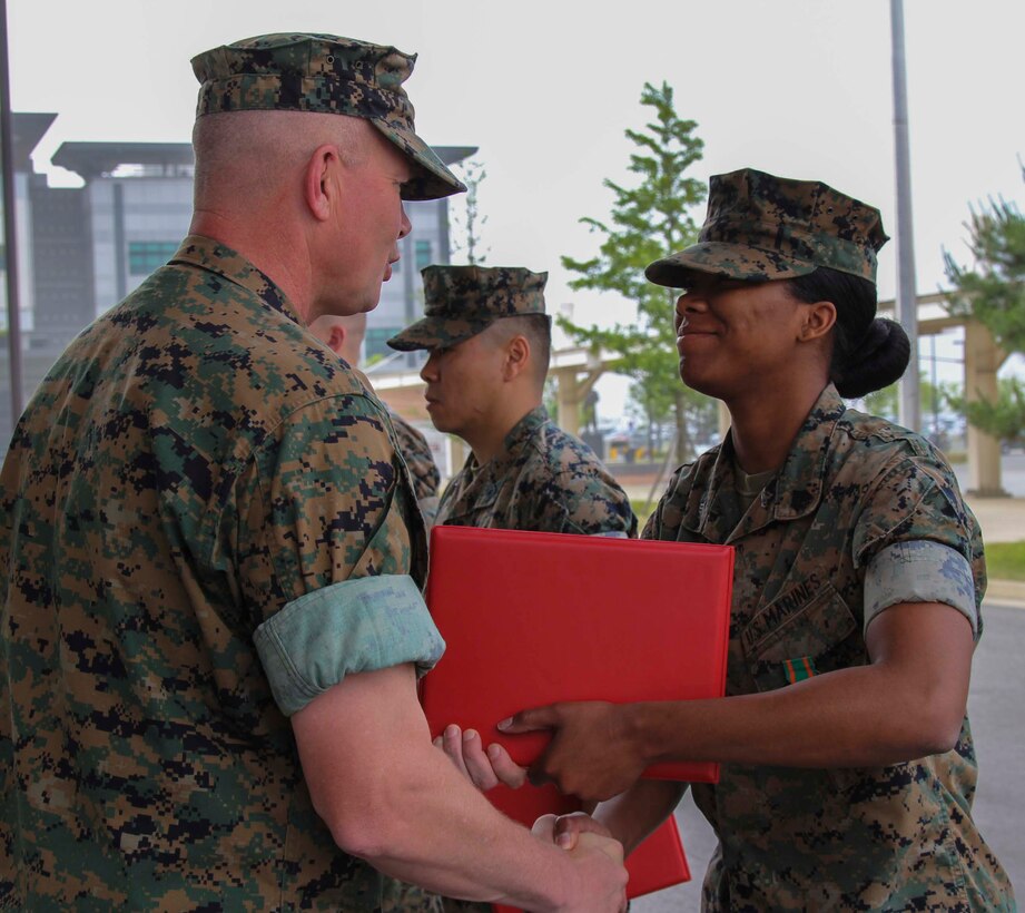 CAMP HUMPHREYS, Republic of Korea – Sgt. Daejahne Williams, U.S. Marine Corps Forces Korea G1 administrative specialist, receives the Navy and Marine Corps Achievement Medal during an awards ceremony here, June 5. Williams was awarded for her excellence in administrative duties, fulfilling the administrative needs of Marines in MARFORK with diligence and without errors. (Official U.S. Marine Corps photo by Sgt. Nathaniel Hanscom/Released)