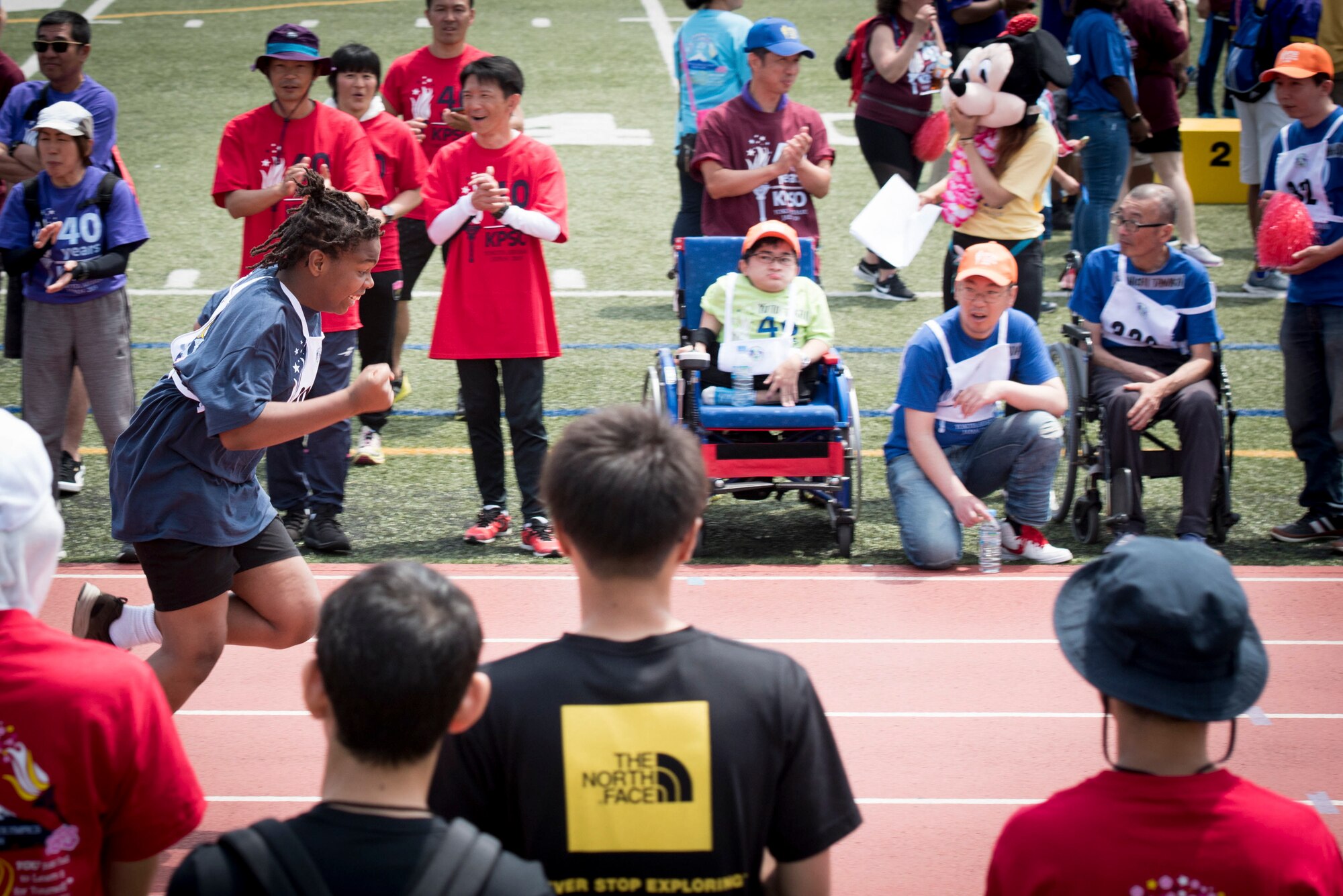 An athlete sprints to the finish line in the 50 meter race during the 40th Annual Kanto Plains Special Olympics at Yokota Air Base, Japan, June 1, 2019.