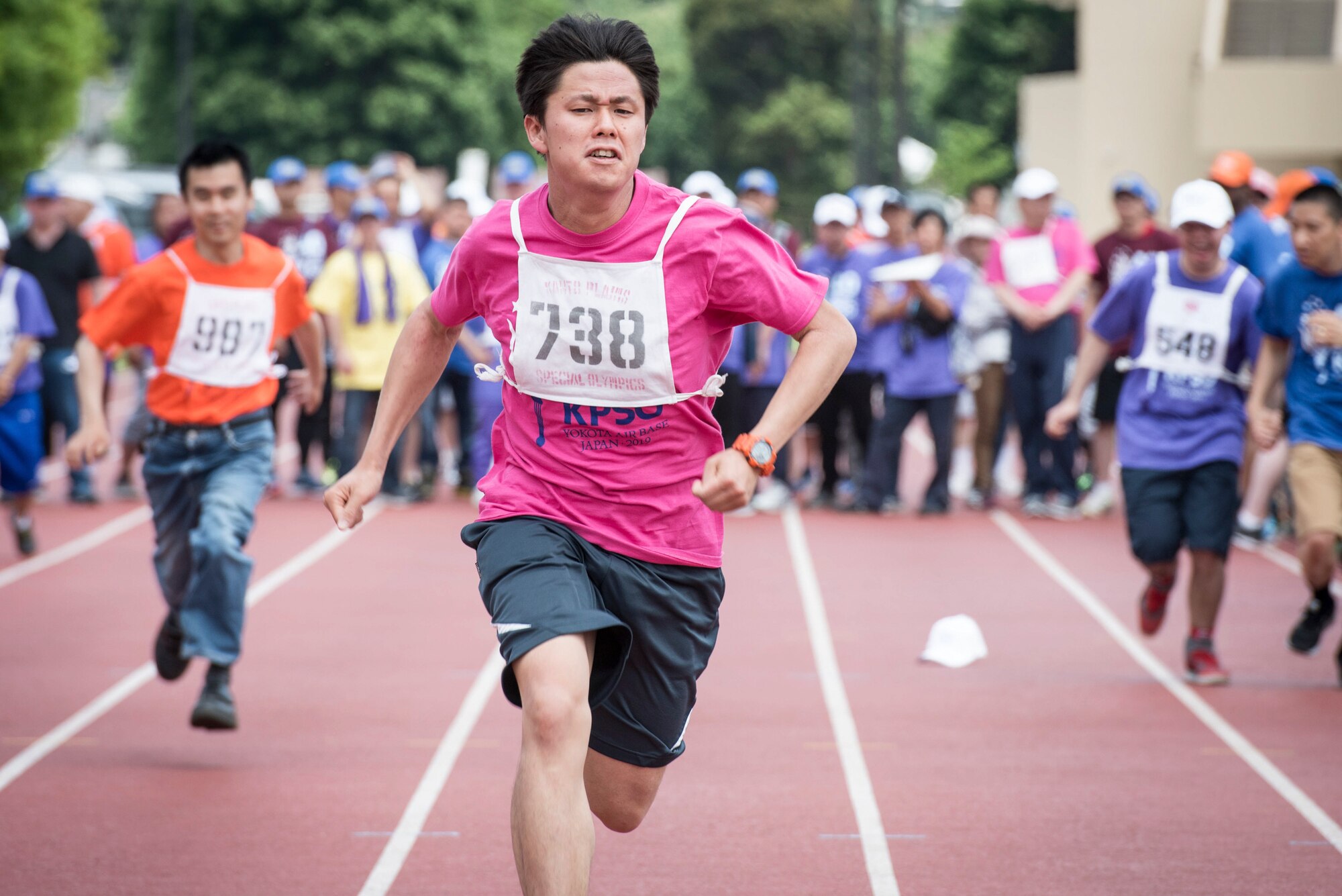 Athletes sprint to the finish line in the 50 meter race during the 40th Annual Kanto Plains Special Olympics at Yokota Air Base, Japan, June 1, 2019.