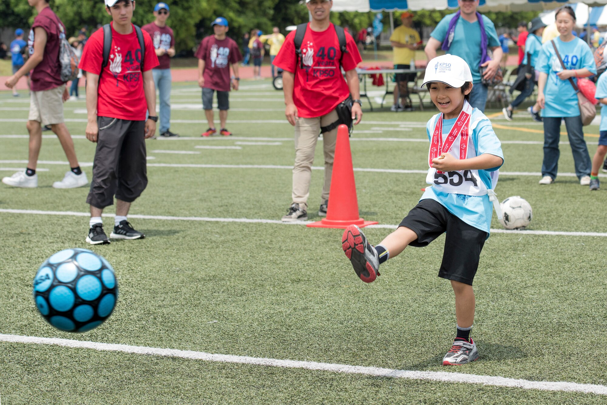 An athlete strikes a ball towards goal during the soccer shoot competition of the Kanto Plains Special Olympics at Yokota Air Base, Japan, June 1, 2019.