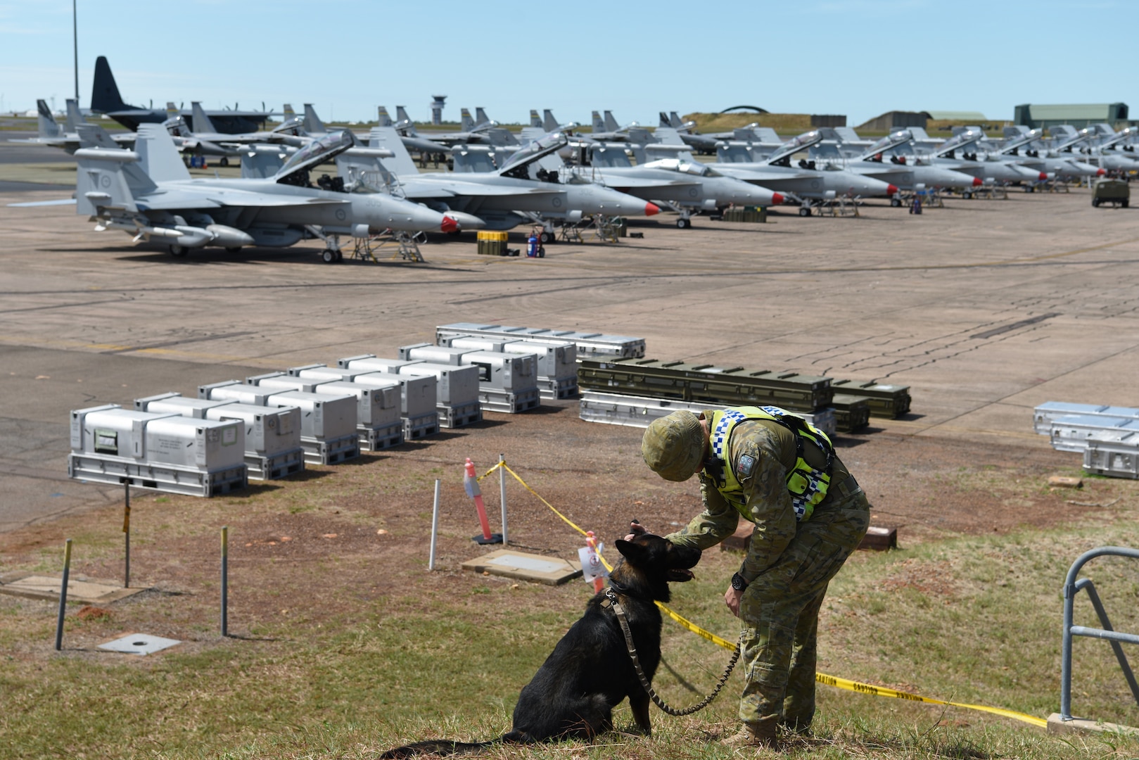 Royal Australian Air Force (RAAF) Leading Air Craftsman Jayden O'Shea, No. 2 Security Forces Squadron military dog handler, and his dog, Deca, watch over an aircraft pad during Exercise Diamond Storm at RAAF Base Darwin, Australia, May 8, 2019. The No. 2 Security Forces Squadron teamed up with the U.S Air Force's 18th Security Forces Squadron from Kadena Air Base, Japan, to protect joint assets on the ground. (U.S. Air Force photo by Staff Sgt. Joshua Edwards)