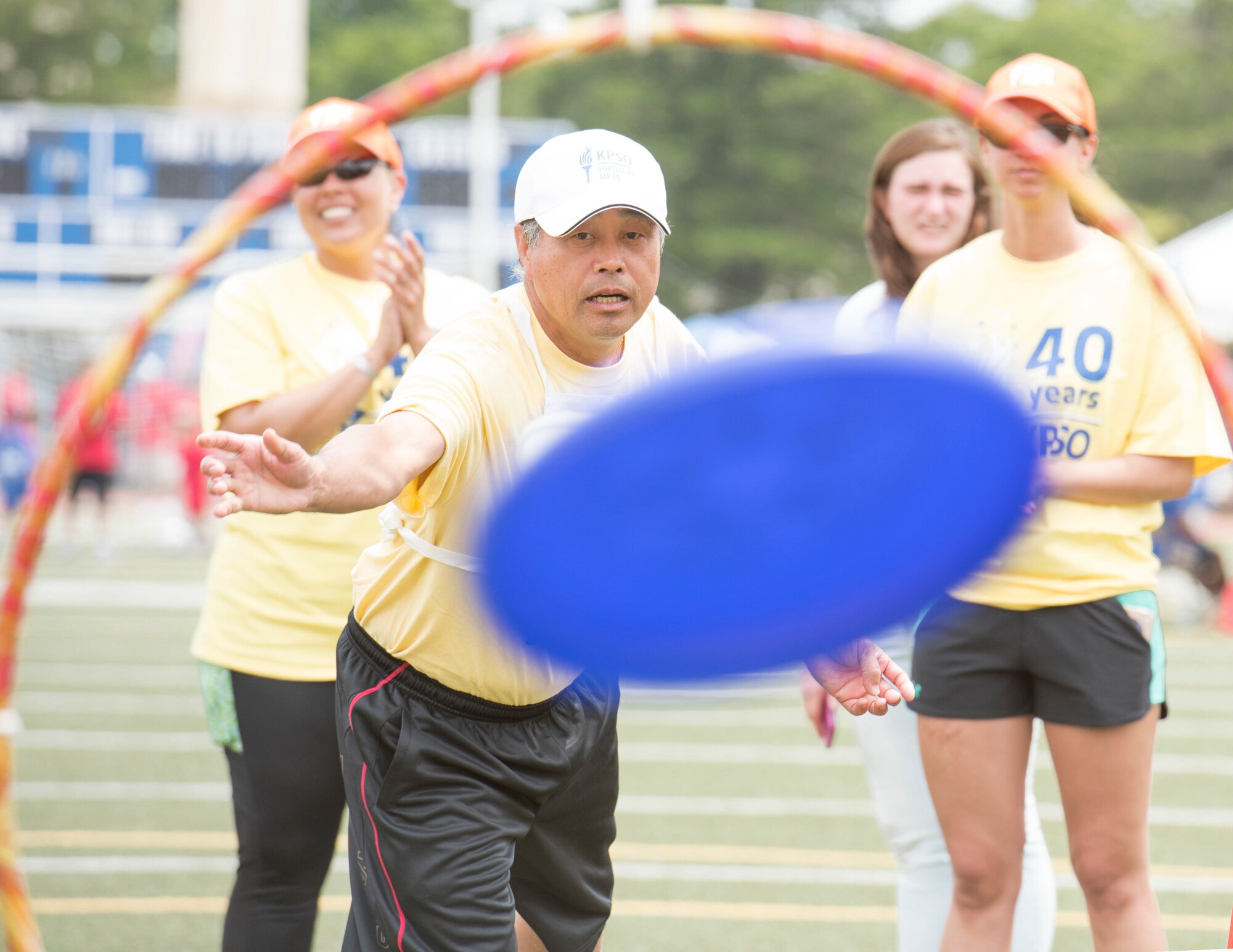 An athlete tosses a Frisbee through a hoop of the flying disc competition during the 40th Annual Kanto Plains Special Olympics at Yokota Air Base, Japan, June 1, 2019.