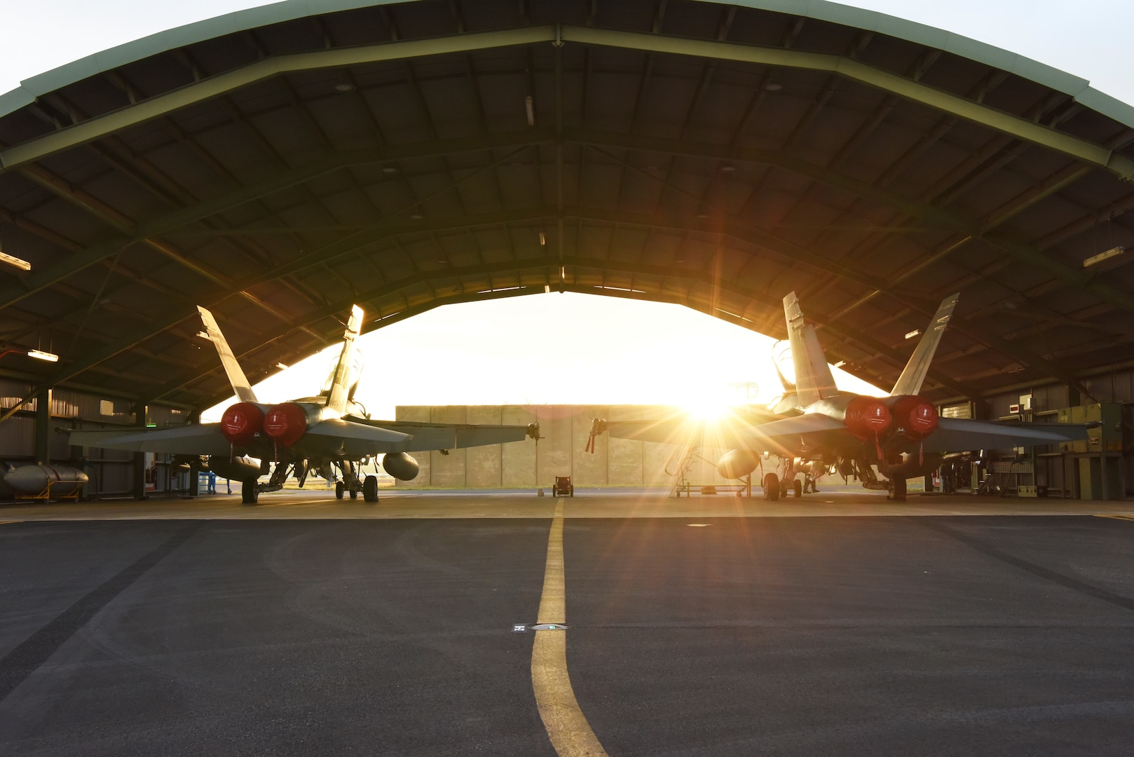 Two Royal Australian Air Force (RAAF) F/A-18B Hornets sit in an overhang during Exercise Diamond Storm at RAAF Base Darwin, Australia, May 10, 2019. This is the last year the RAAF will use the F/A-18A and B models for Exercise Diamond Storm before updating to the F-35 Lightning II. (U.S. Air Force photo by Staff Sgt. Joshua Edwards)