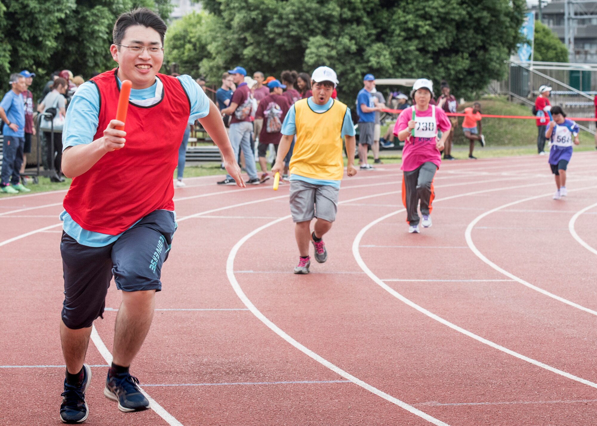 Athletes run in the 400 meter relay during the 40th Annual Kanto Plains Special Olympics at Yokota Air Base, Japan, June 1, 2019.