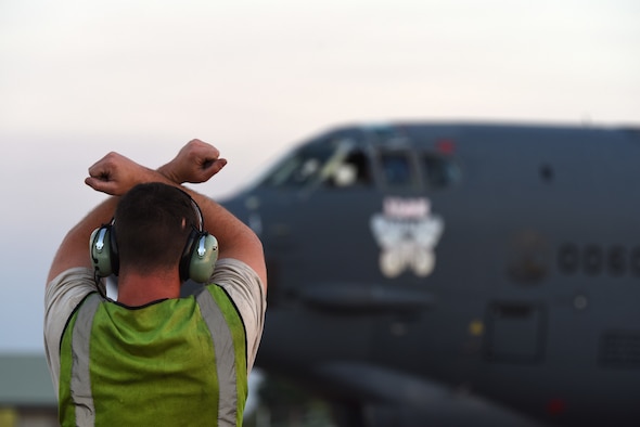 U.S. Air Force Airman 1st Class David Chorjel, 23rd Expeditionary Maintenance Squadron crew chief, signals for the pilots to hold the B-52 Stratofortress in place during Exercise Diamond Storm at RAAF Base Darwin, Australia, May 15, 2019. The B-52s allowed for simulated target strikes to aid in the exercise training efforts. (U.S. Air Force photo by Staff Sgt. Joshua Edwards)