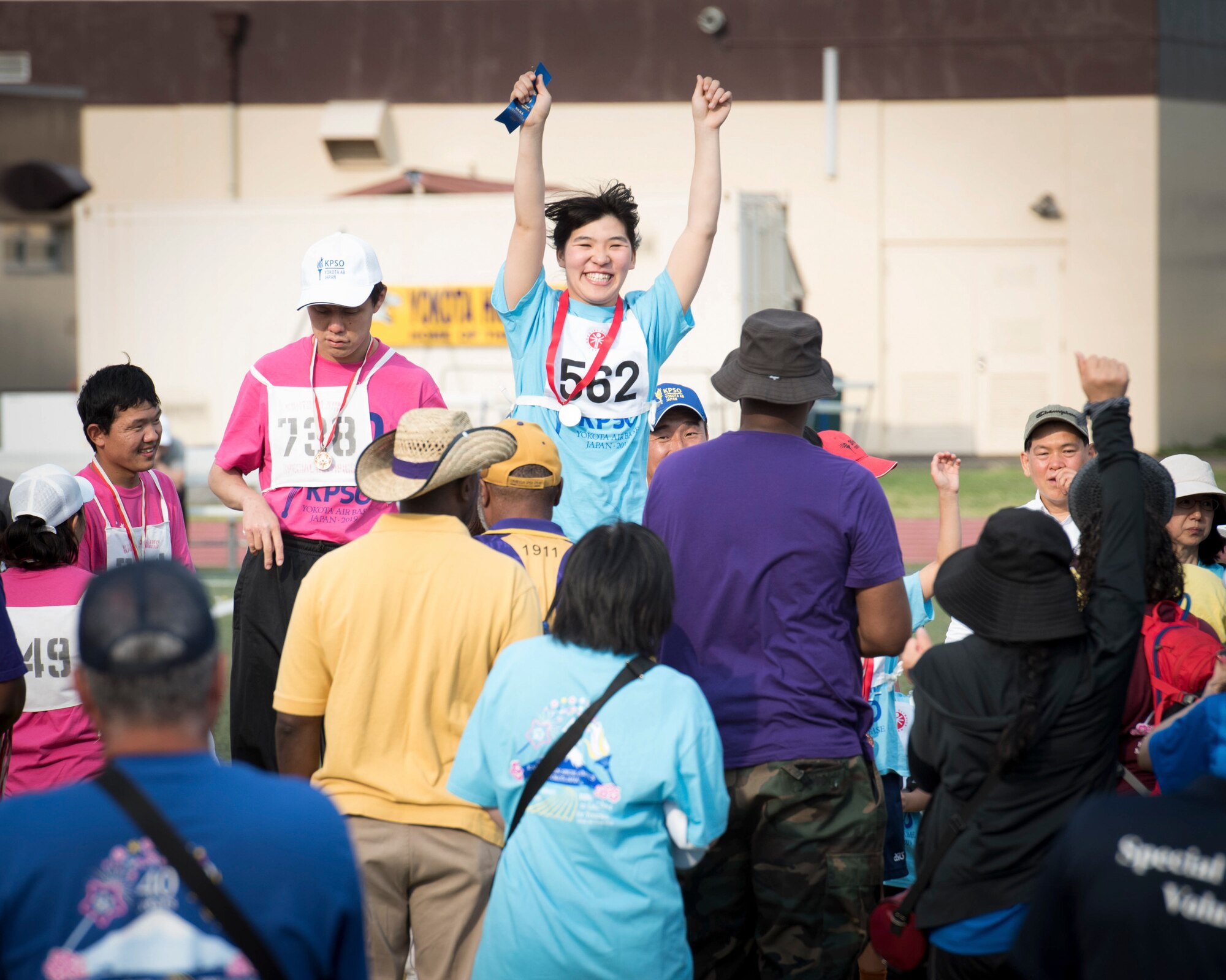 Athletes celebrate receiving a medal during the medal ceremony of the 400 meter relay race during the 40th Annual Kanto Plains Special Olympics at Yokota Air Base, Japan, June 1, 2019.