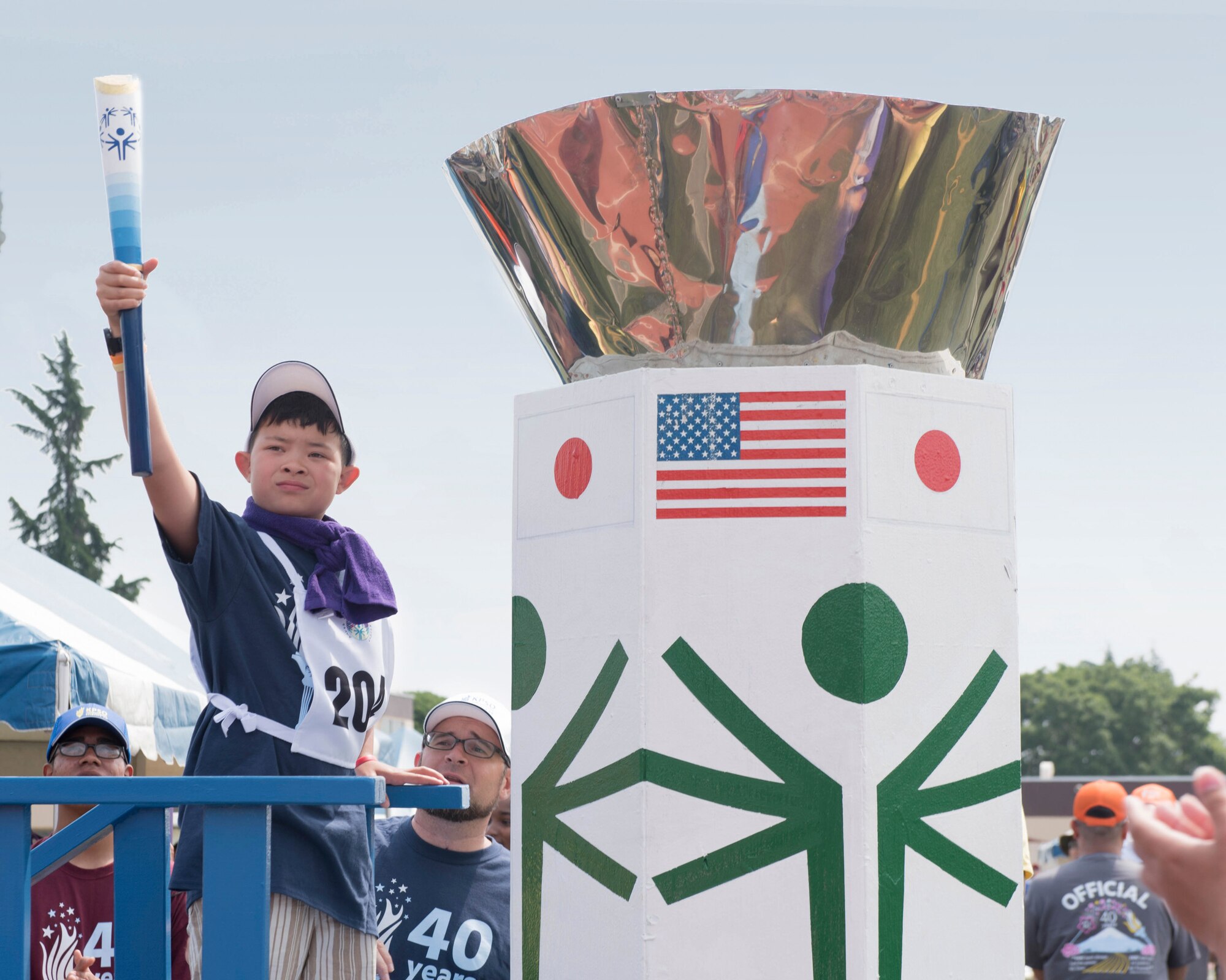 Bibb Yamamoto, representing the Department of Defense Education Activity, prepares to the light the torch at the Kanto Plains Special Olympics opening ceremony at Yokota Air Base, Japan, June 1, 2019.