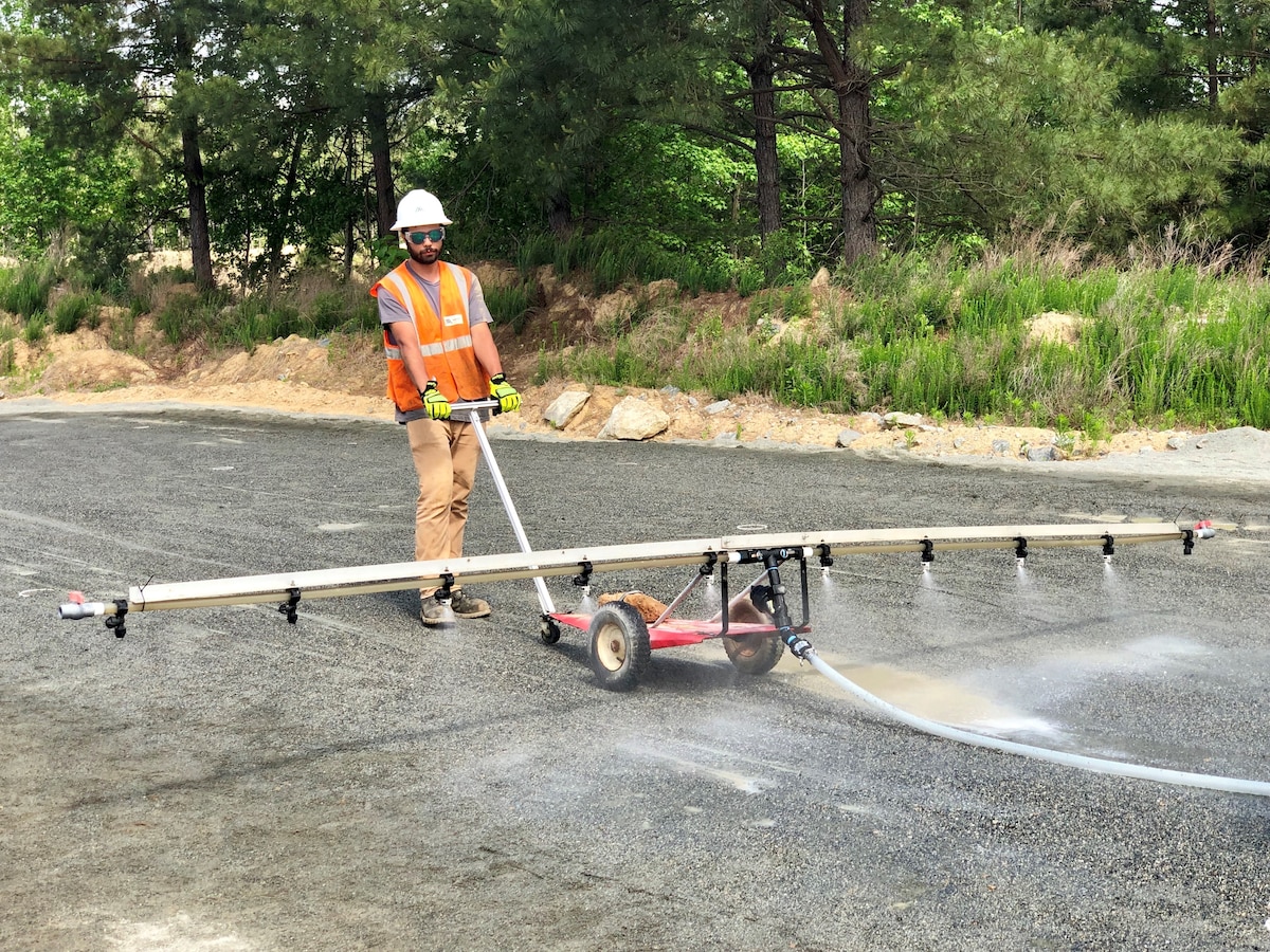 Kenley McAdams, from bioMASON, applies a feeding to the bacteria to harden the surface of the Project Medusa 2,500 square foot prototype in Durham, North Carolina. (Photo courtesy of James O’Rourke)