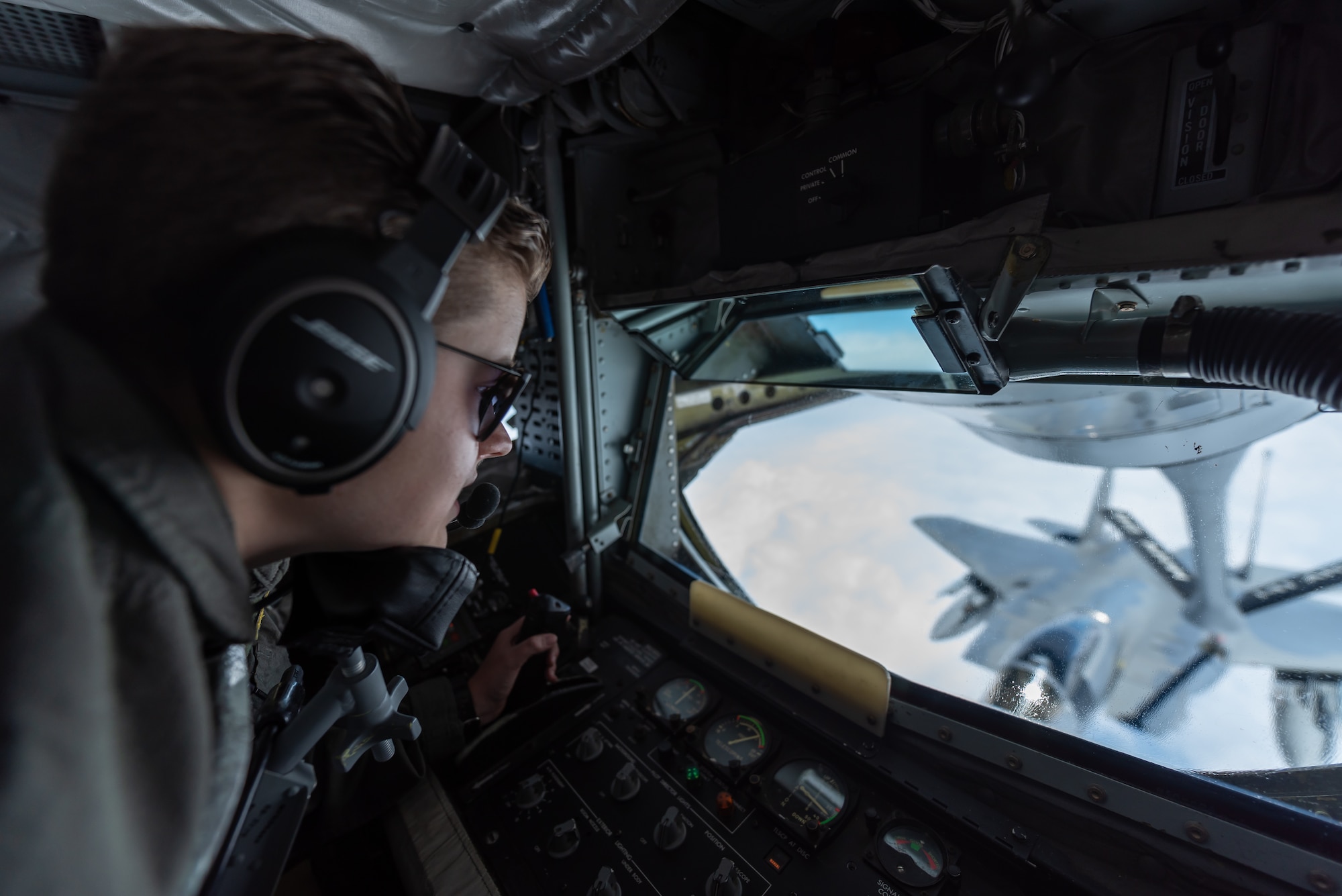 U.S. Air Force Airman 1st Class Brooke Griffin, 909th Air Refueling Squadron boom operator, refuels an F-15C Eagle April 15, 2019, during a routine training exercise out of Kadena Air Base, Japan. The 909th ARS helps ensure a free-and-open Indo-Pacific by providing air refueling to U.S., allies and partners within the area of responsibility. (U.S. Air Force photo by Airman 1st Class Matthew Seefeldt)