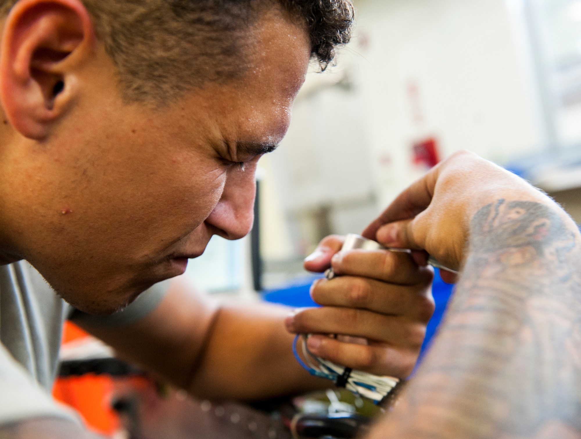 U. S. Air Force Airman 1st Class Geoffrey Negrete, armament maintenance member assigned to the 18th Equipment Maintenance Squadron, adjusts wires of an AIM-9L/M Sidewinder missile rack at Kadena Air Base, Japan, May 29, 2019.