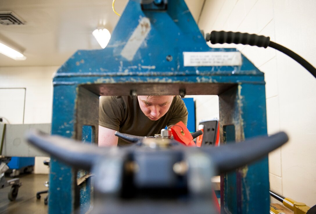 U. S. Air Force Airman 1st Class Brock Davis, armament maintenance member assigned to the 18th Equipment Maintenance Squadron, sets an MAU-12 bomb rack on a proofload tester at Kadena Air Base, Japan, May 29, 2019.