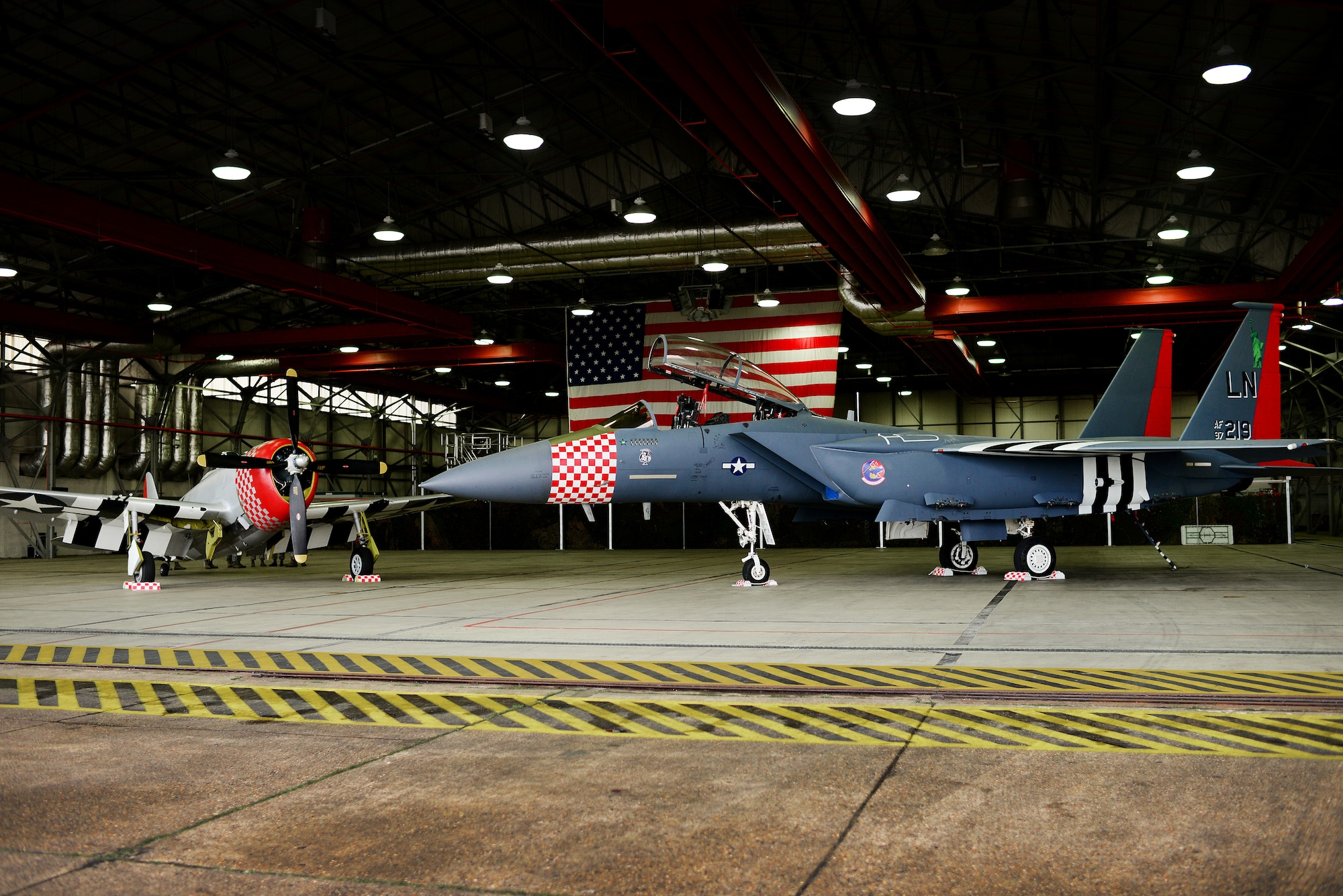 An F-15E Strike Eagle assigned to the 492nd Fighter Squadron is painted in the heritage colors of its World War II P-47 Thunderbolt predecessor at Royal Air Force Lakenheath, England Jan 31. The 48th Fighter Wing officially unveiled the aircraft publicly during a ceremony on Jan 31. (U.S. Air Force photo/Tech. Sgt. Matthew Plew)