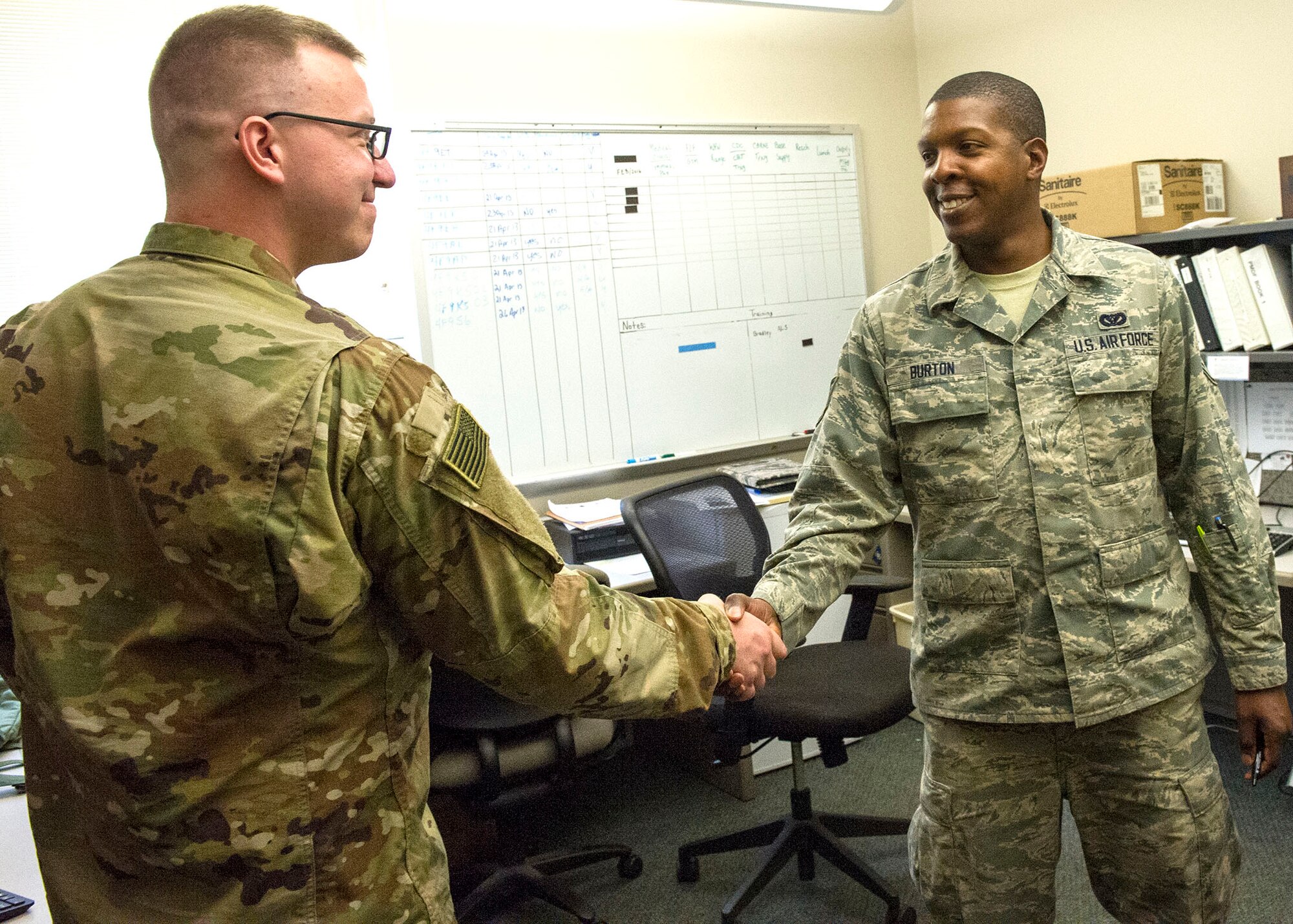 Staff Sgt. James Burton, a 434th Civil Engineer Squadron Water and Fuel Systems technician, welcomes an Airman to his office for a career advising appointment at Grissom Air Reserve Base, Ind., June 2, 2019. Burton considered leaving the Air Force but later became a career advisor to help others in their careers. 
(U.S. Air Force photo by Staff Sgt. Courtney Dotson-Essett)