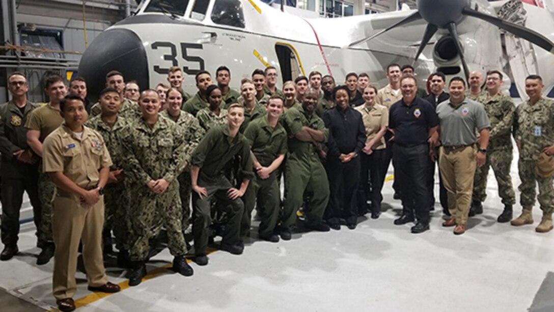 Navy and DLA members pose for photo after expediting a part