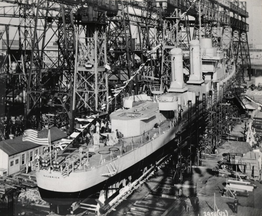 Among the five classes of ships NNSY built or modernized to support the invasion of Normandy on June 6, 1944, the shipyard constructed two destroyers.  The first was USS Herndon (DD-638), commissioned December 1942. On June 6, Herndon was ahead of the first wave of troops raining a volley of shells upon enemy targets on Omaha Beach. Despite drawing heavy fire, Herndon not only remained intact but stayed another two weeks shoring up the Allied grip on the region.   The 1,630-ton destroyer USS Shubrick (DD-639) was also constructed in 1942, in record time, at NNSY.  Shubrick supported Normandy clearing the beach at Belfast for Allied troops.   Shubrick stayed in the region well into July, serving as escort, providing fire support, and conducting anti-submarine patrols.