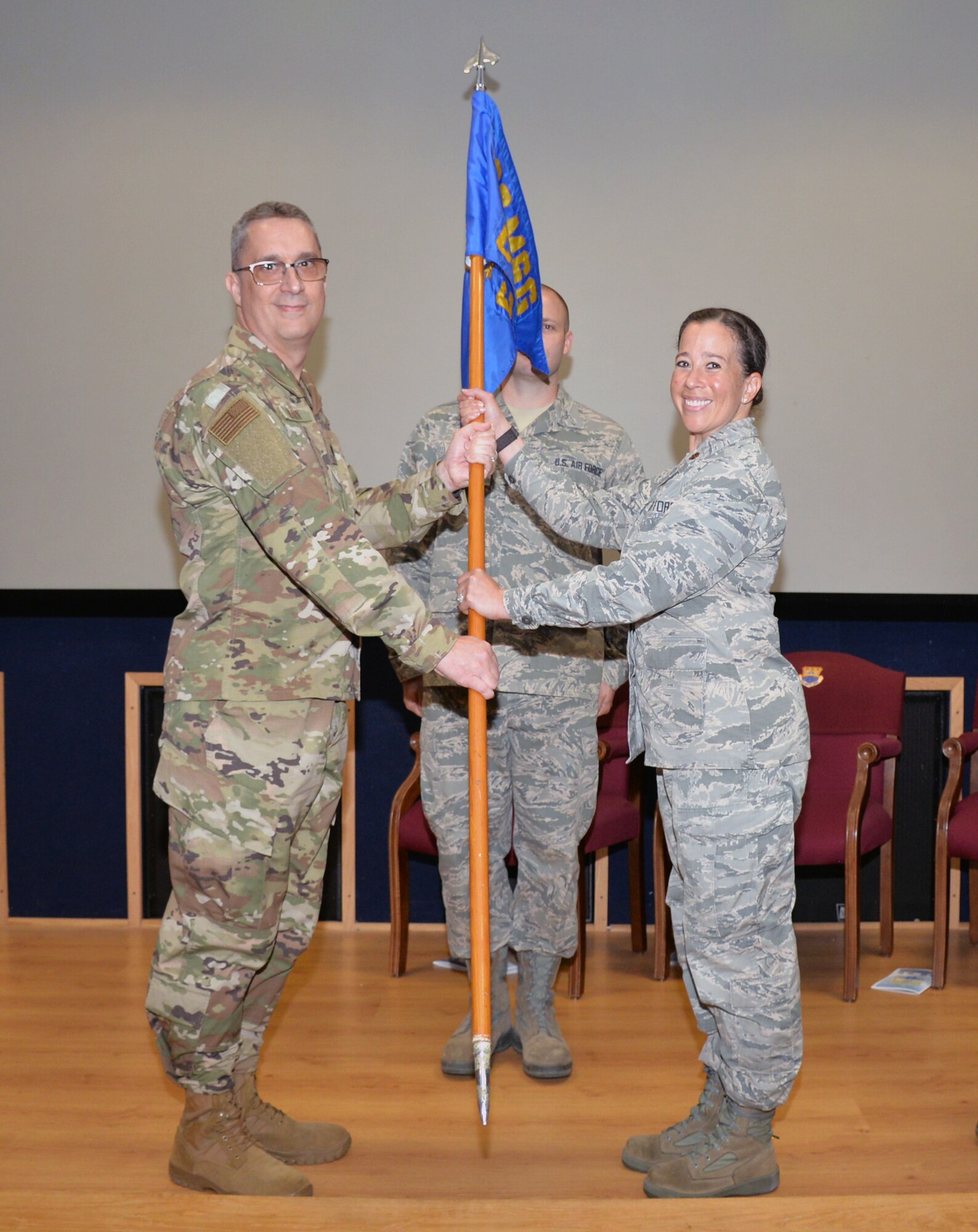 Lt. Col. James A. Hearn III, 433rd Mission Support Group deputy commander, presents the guidon to Maj. Jaime L. “Leigh” Barker, 433rd Civil Engineer Squadron commander, signifying the assumption of squadron command June 1, 2019 at Joint Base San Antonio-Lackland, Texas.