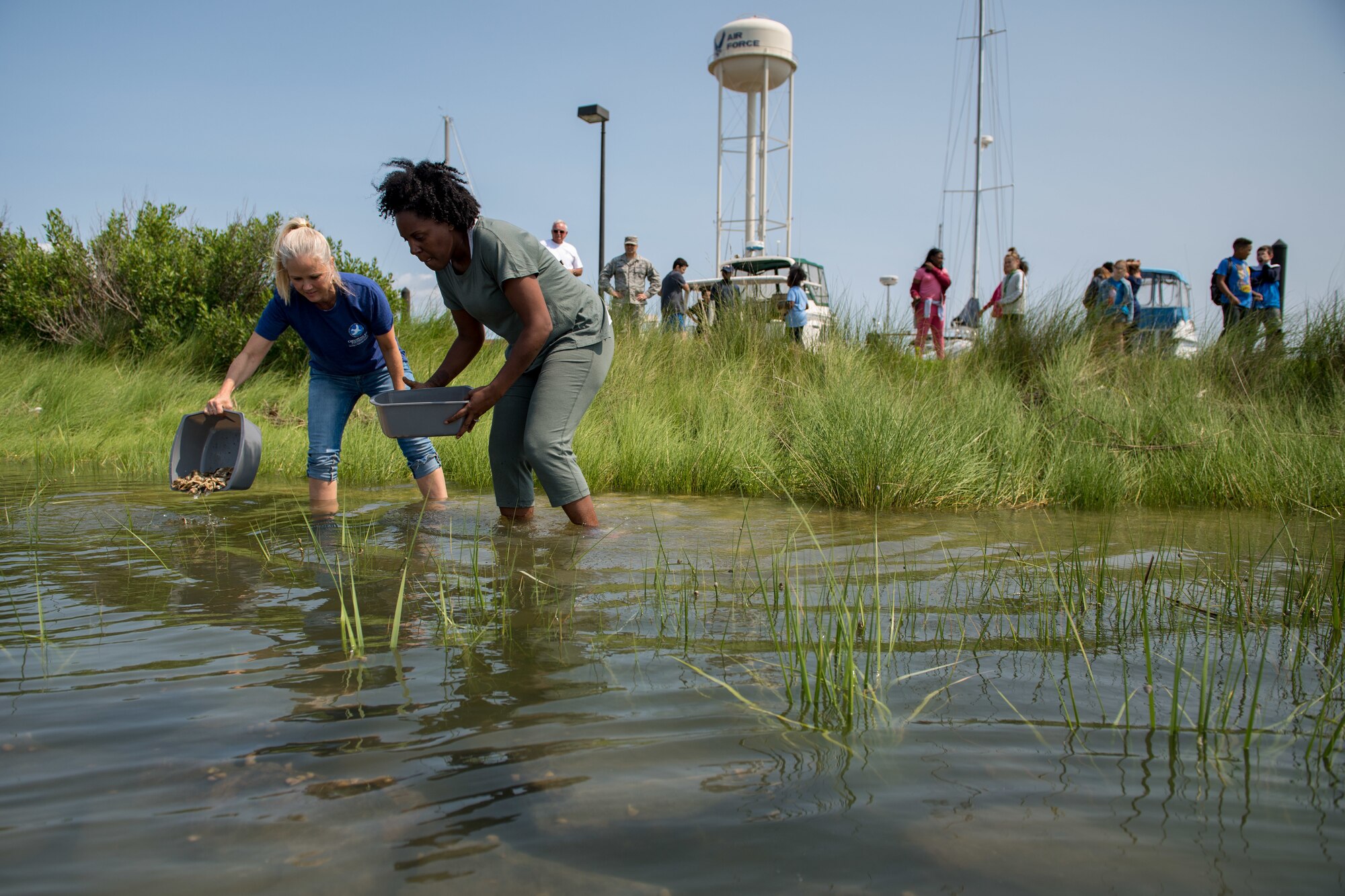 Booker Elementary School teachers add new oysters to the reef at Joint Base Langley-Eustis, Virginia, June 3, 2019.