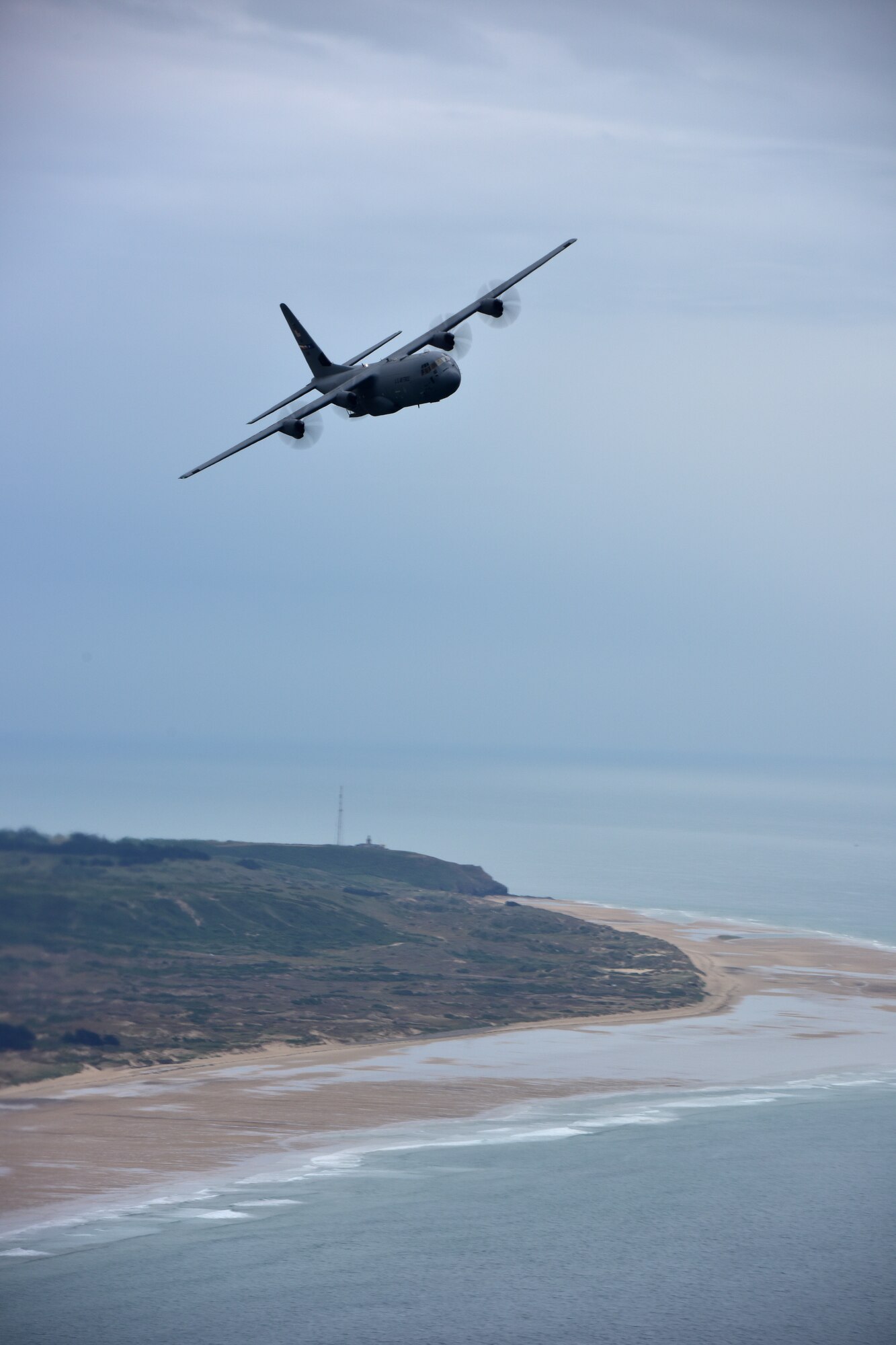 One C-130s fly in the air