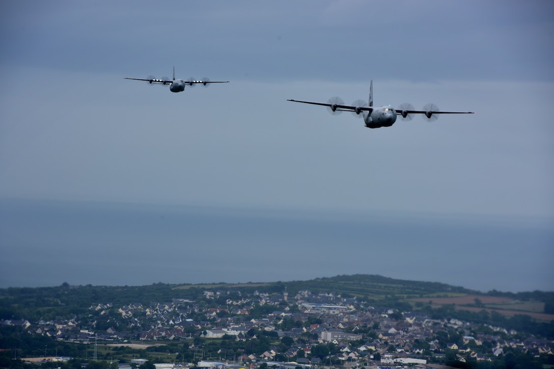 Two C-130s fly in the air