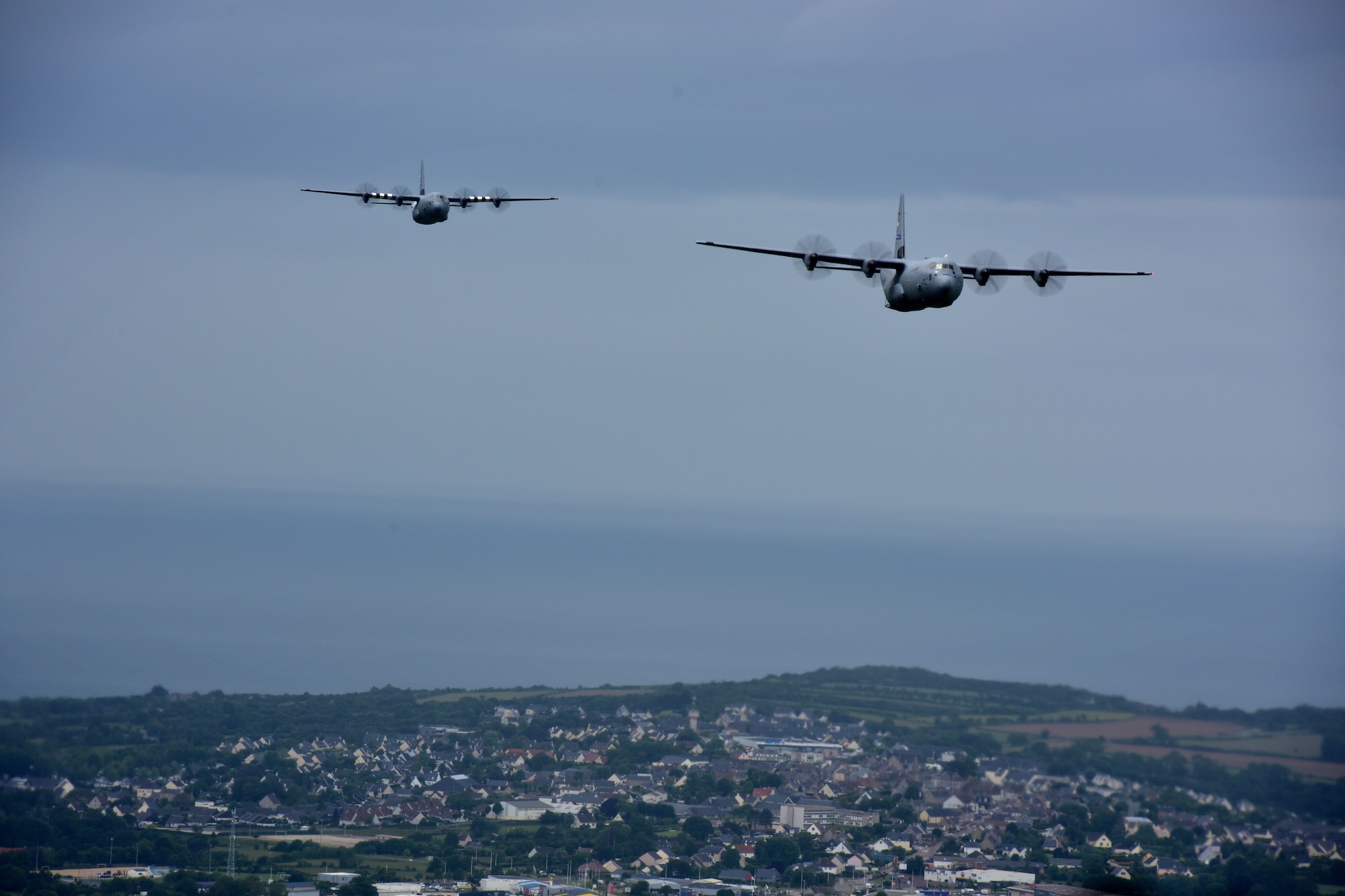 Two C-130s fly in the air