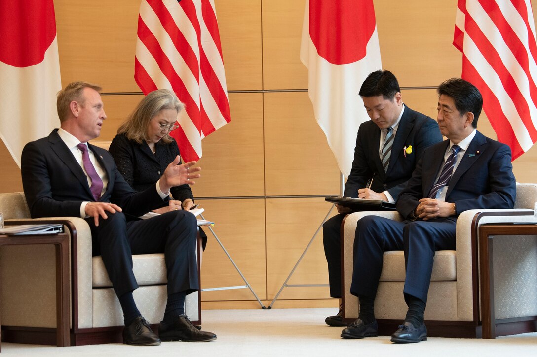 Leaders meet to talk while others take notes.