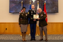 U.S. Army Recruiting Command Team, Maj. Gen Frank Muth and Command Sgt. Maj. Tabitha Gavia present Sgt. 1st Class Greg Waters with the Distinguished Service Cross.